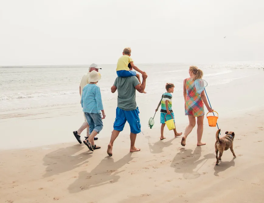 Family walking along Berrow Beach near Brean and Burnham-on-Sea during a Somerset beach holiday